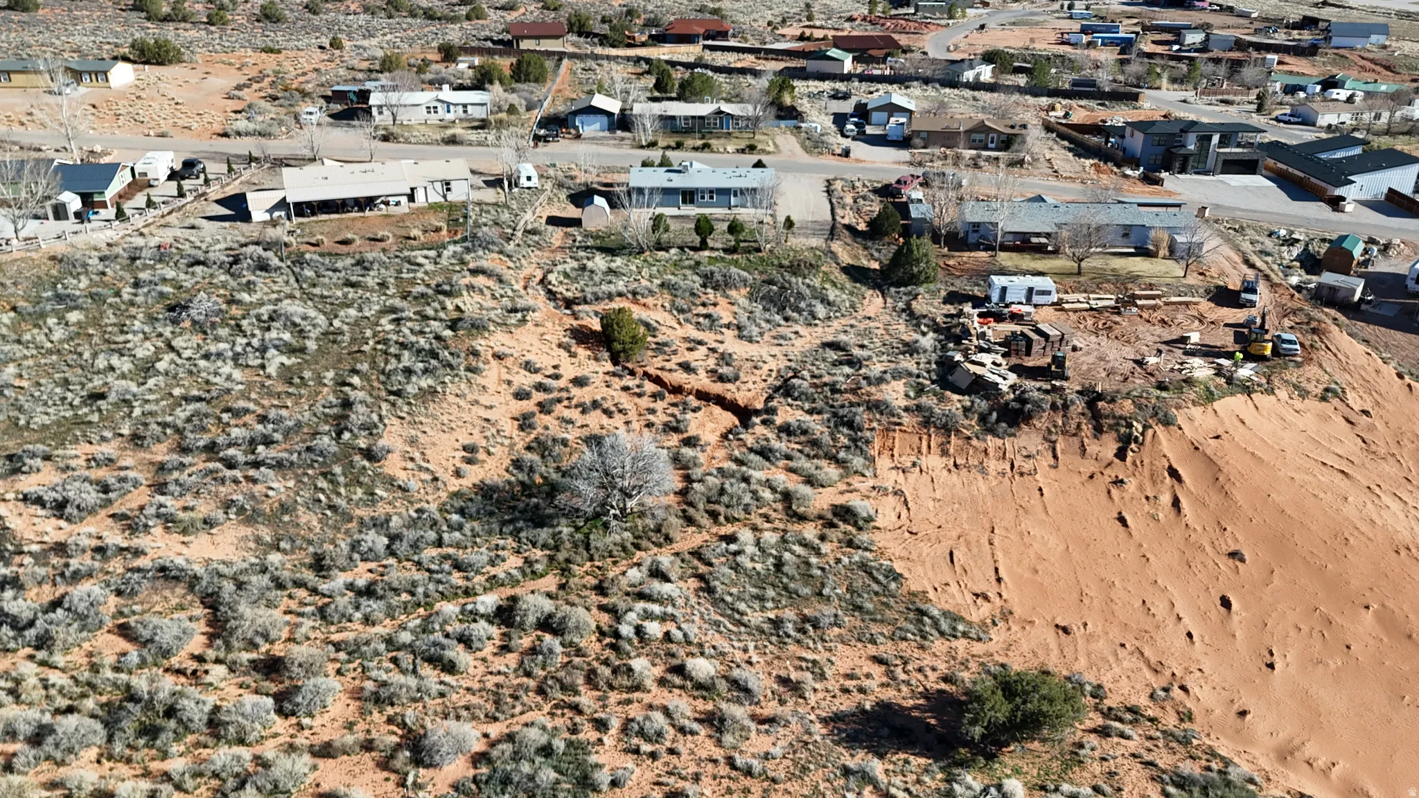 Aerial view of property and surrounding area with a desert landscape
