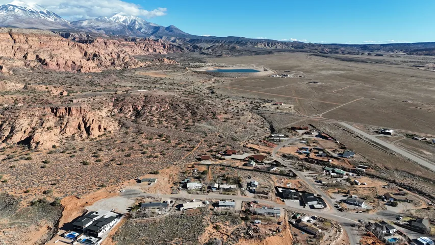 Aerial view of property's location featuring a mountainous background and rural landscape