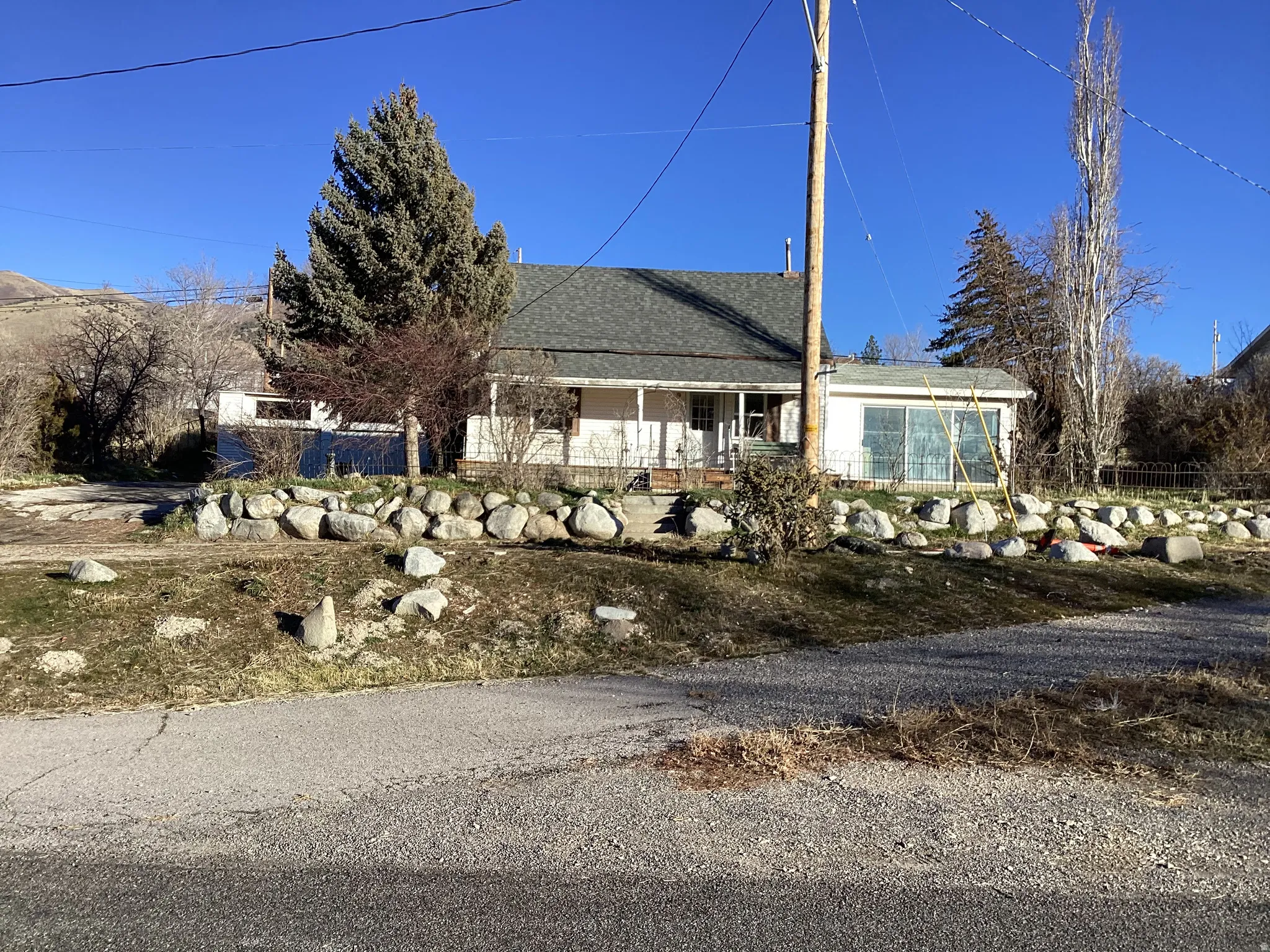 View of front of house with a shingled roof