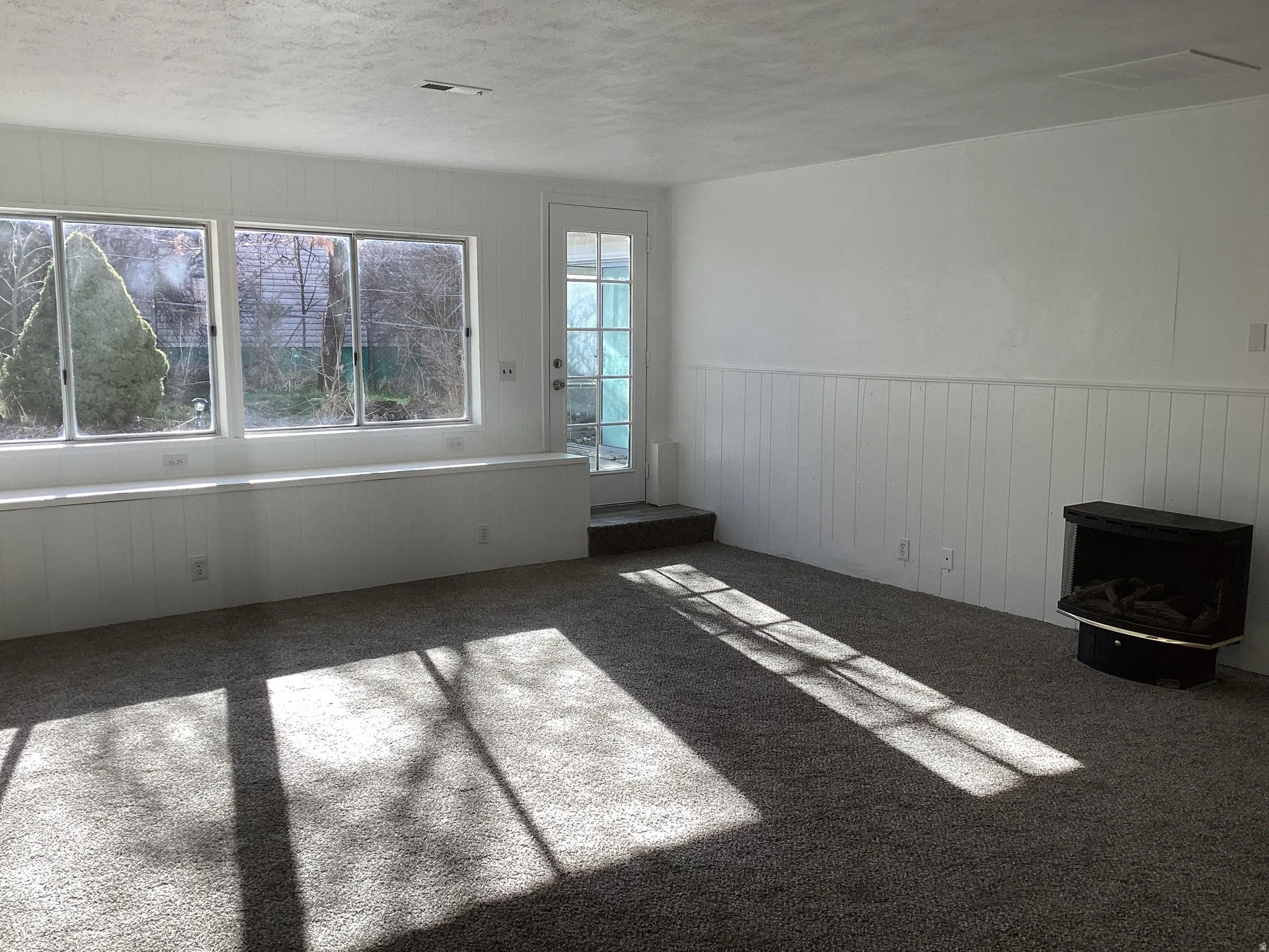 Very large living room / sunroom featuring plenty of natural light and a cozy gas fireplace