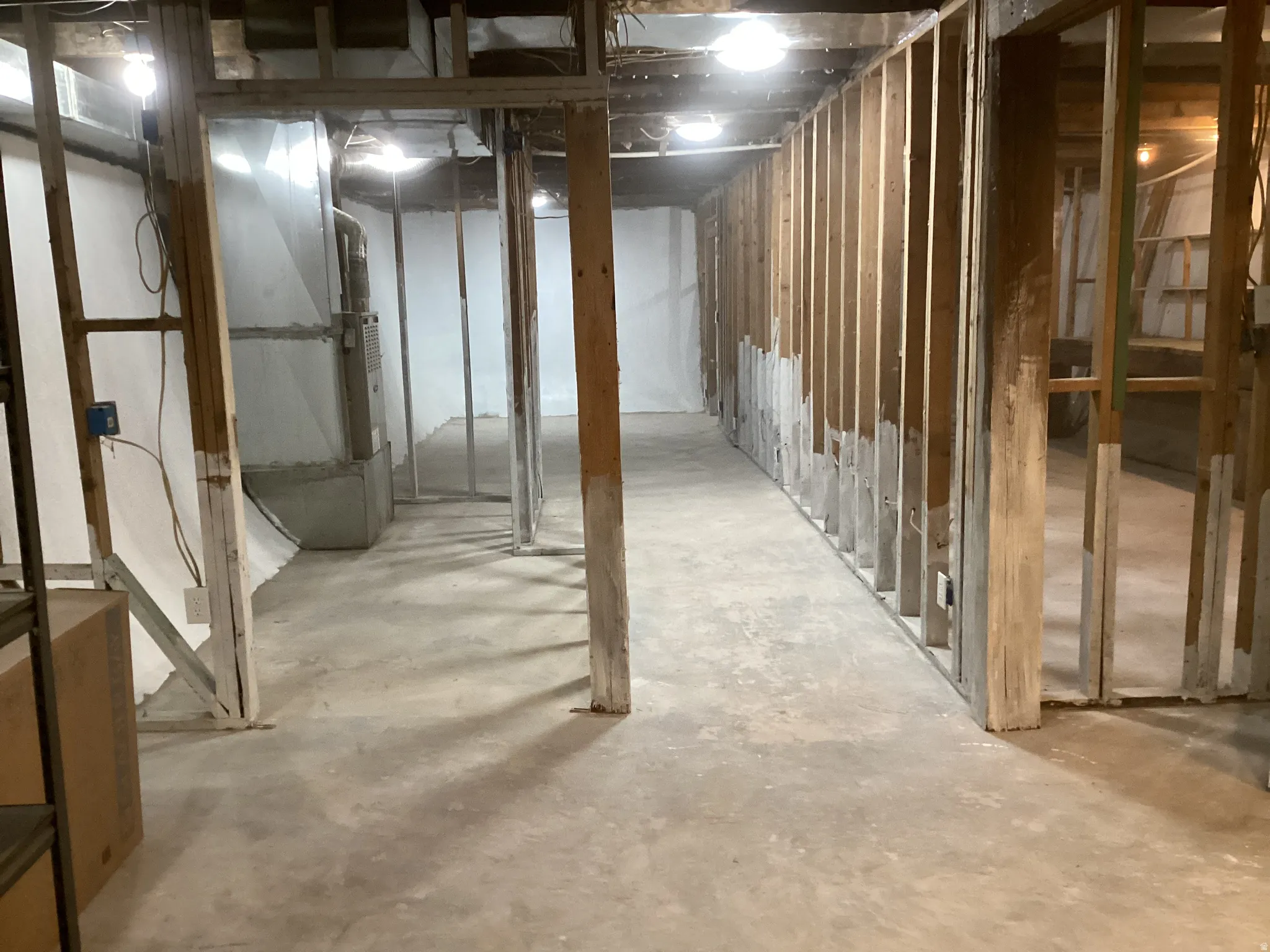 Unfinished below grade area featuring heating unit