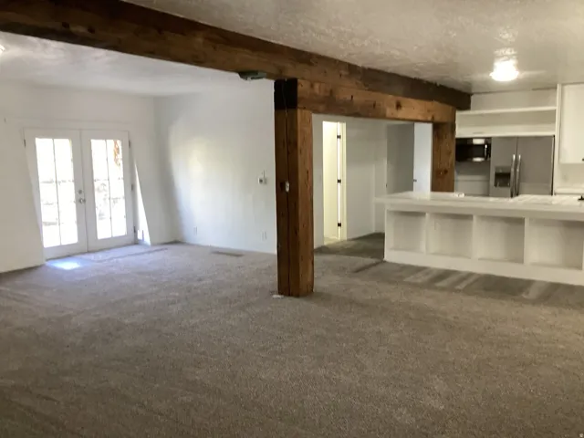 Large living room, kitchen, bathroom and bar with tile and LVP flooring.
