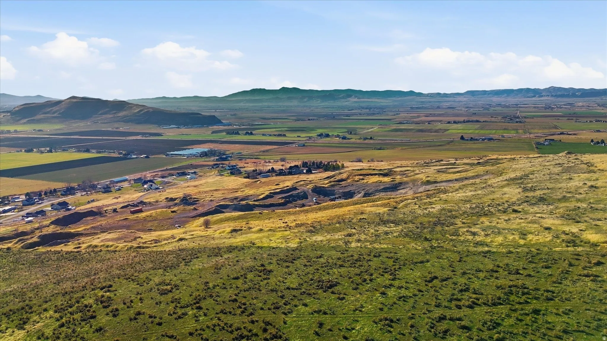 View of mountain backdrop featuring rural landscape