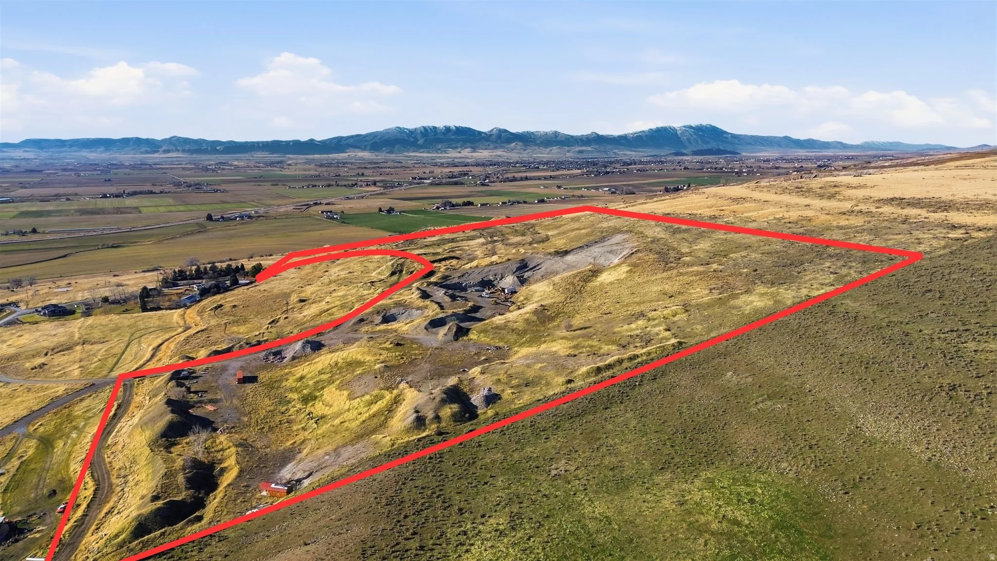 Aerial overview of property's location with property boundaries highlighted and rural landscape