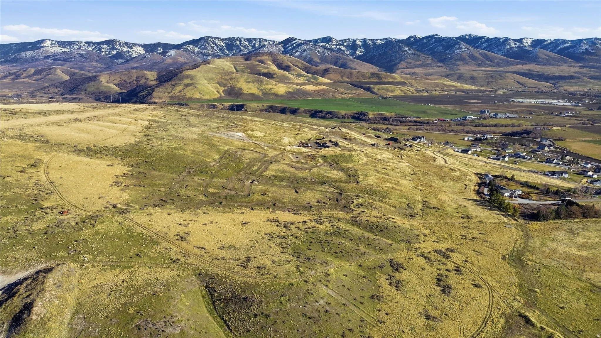 View of mountain backdrop with rural landscape