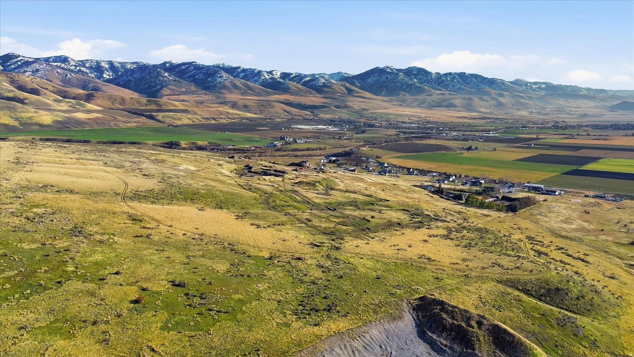 View of mountain backdrop with rural landscape