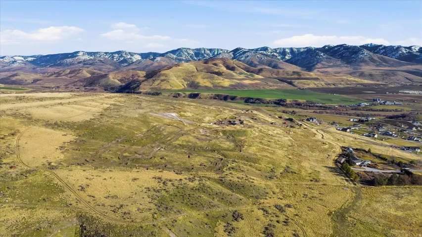 View of mountain backdrop featuring rural landscape