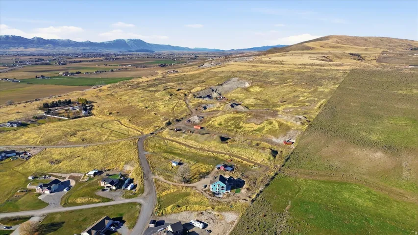 Aerial overview of property's location featuring a mountain backdrop and rural landscape