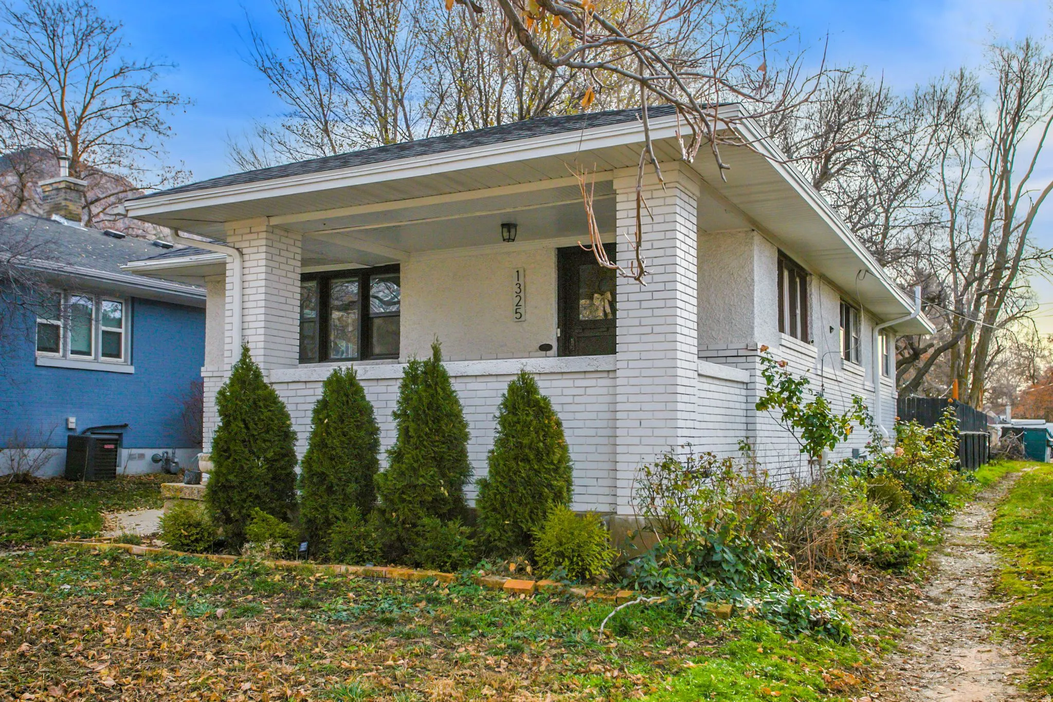 View of side of property featuring brick siding and a central AC unit