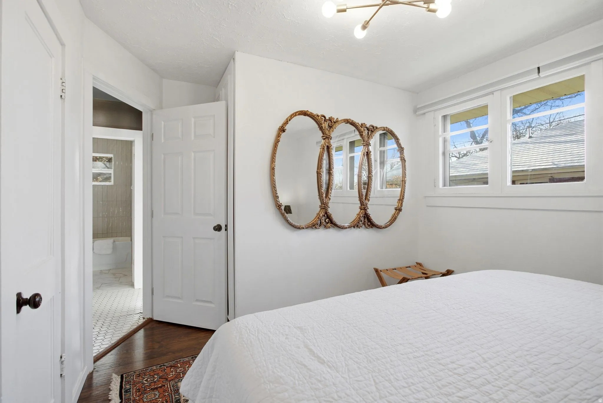 Bedroom featuring dark wood-type flooring and a chandelier