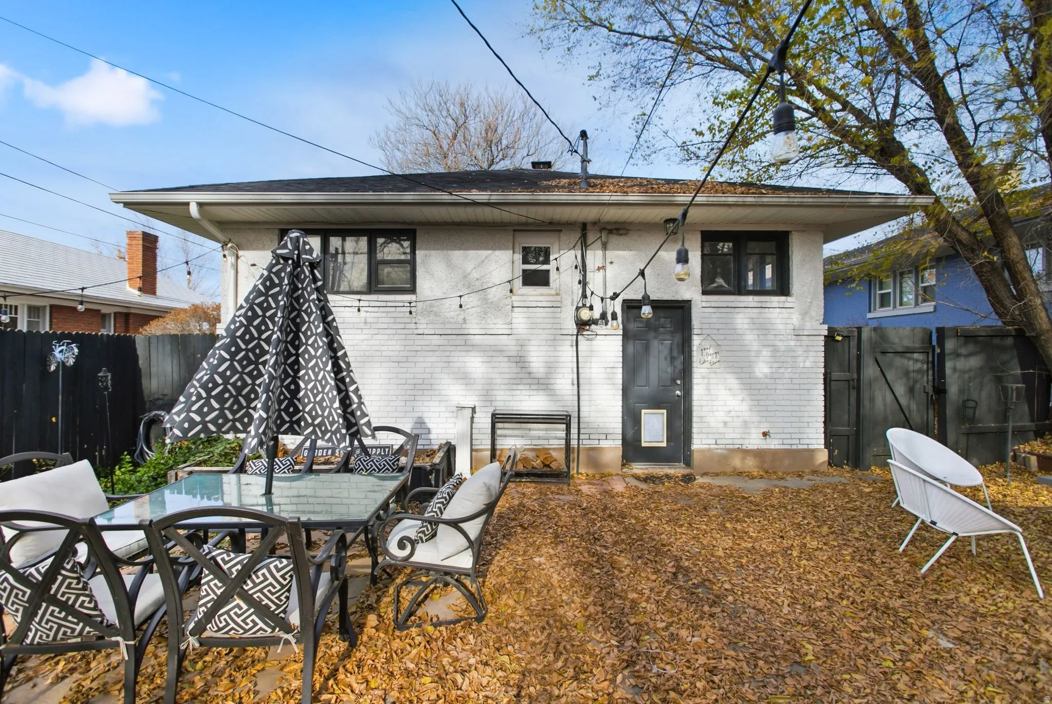 Rear view of house featuring brick siding and outdoor dining space