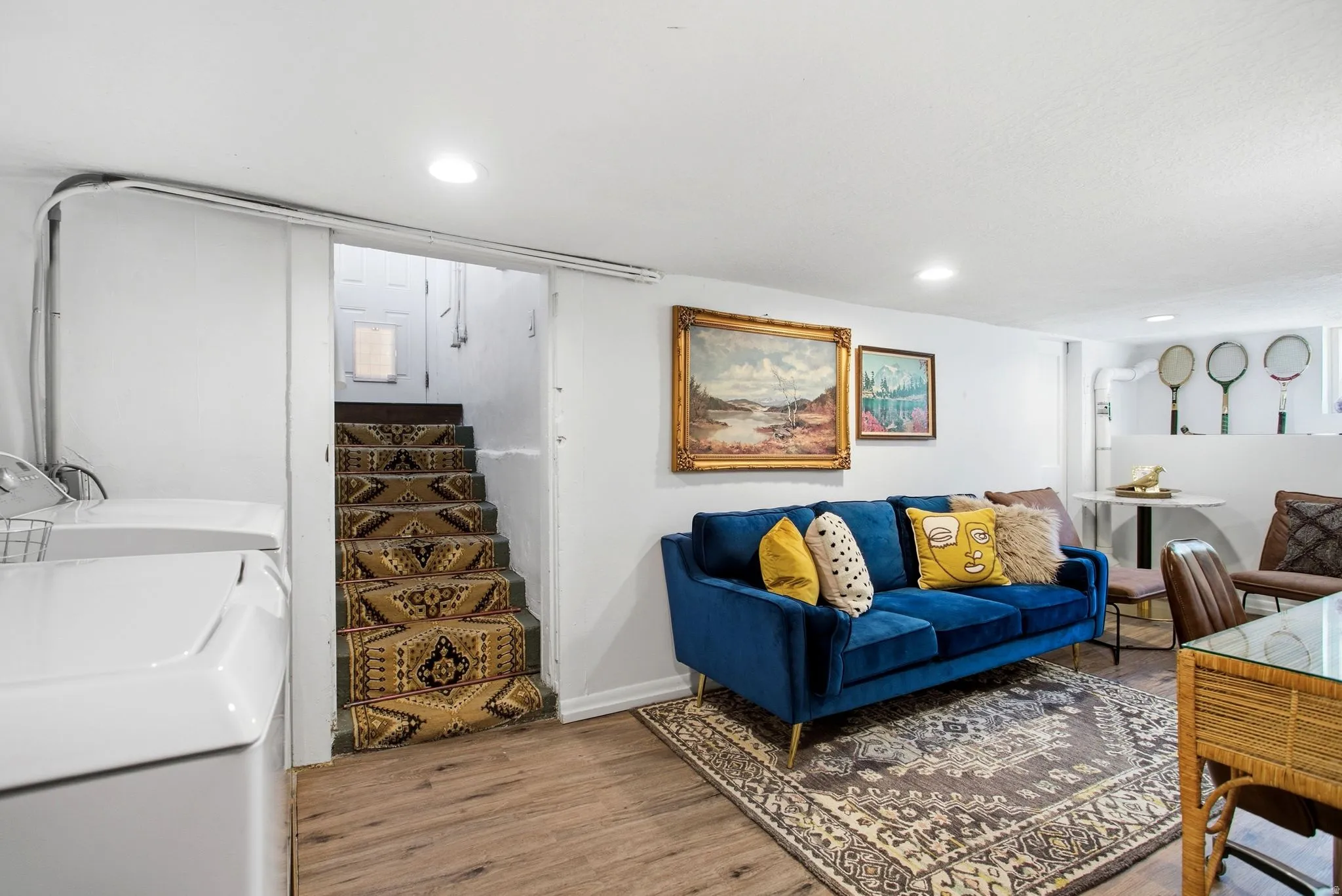 Living room featuring light wood-style floors, separate washer and dryer, stairs, and recessed lighting