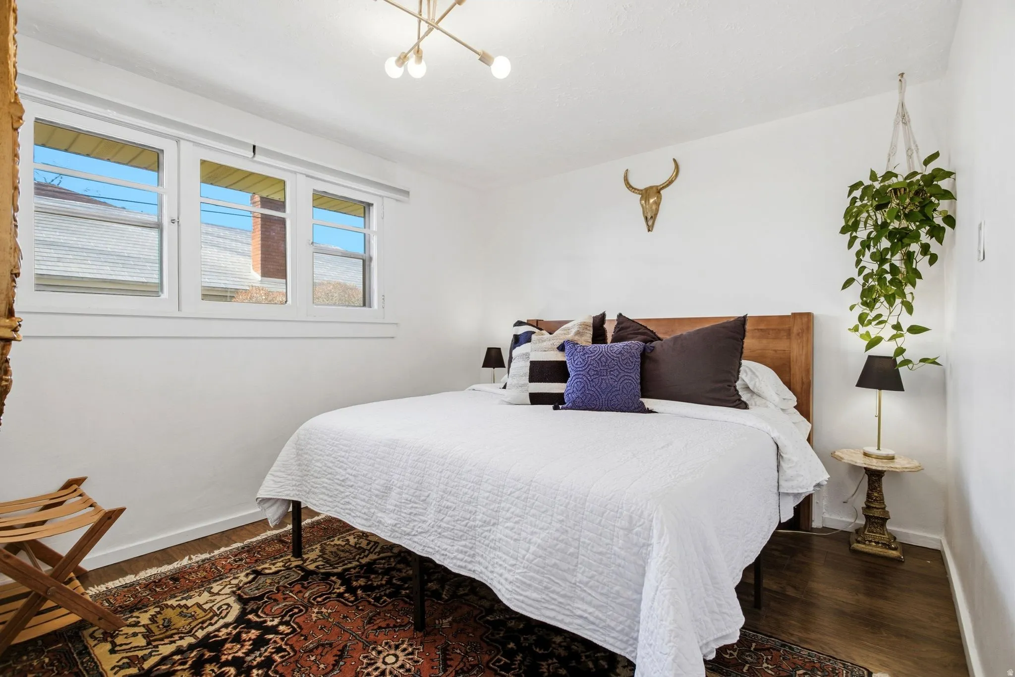 Bedroom featuring wood finished floors and a chandelier