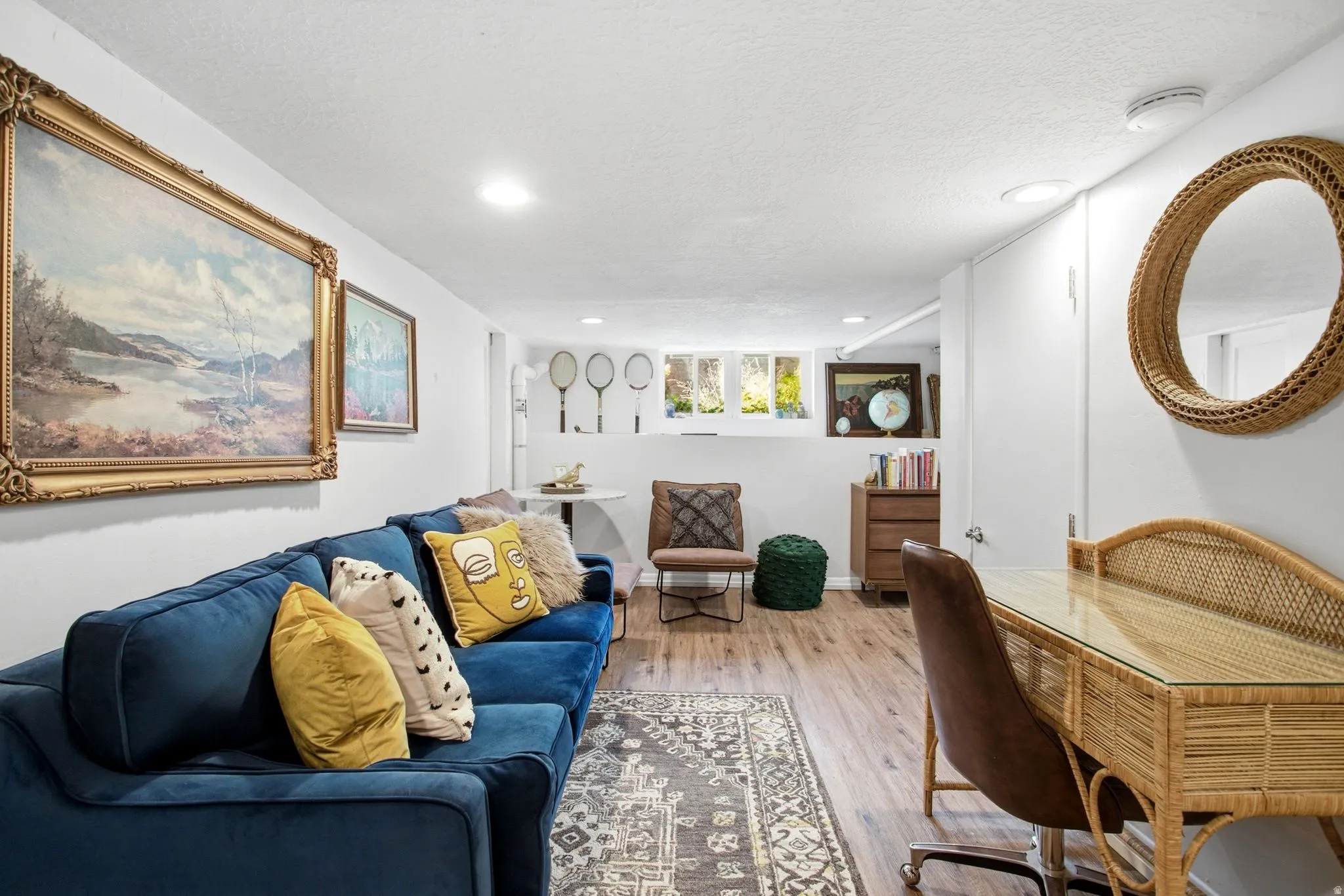 Living area featuring light wood-style flooring and a textured ceiling