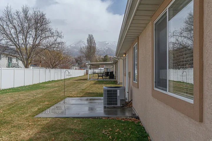 Fenced backyard featuring a mountain view and a patio area