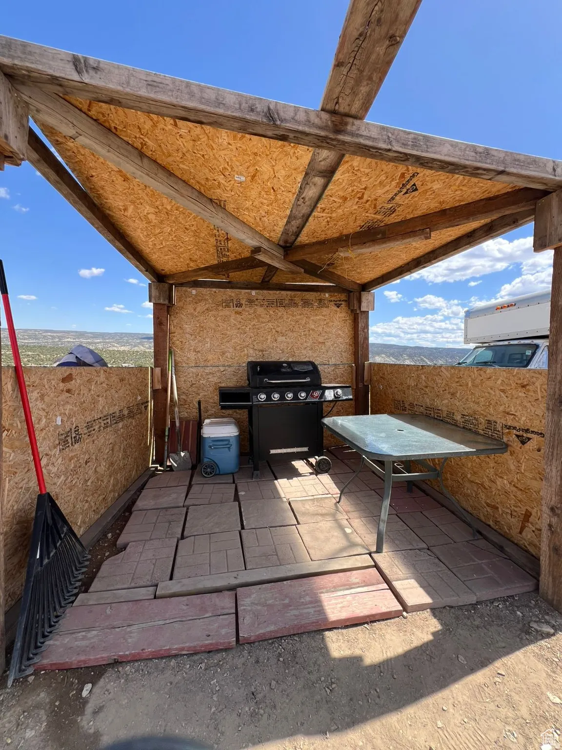 View of patio with a grill