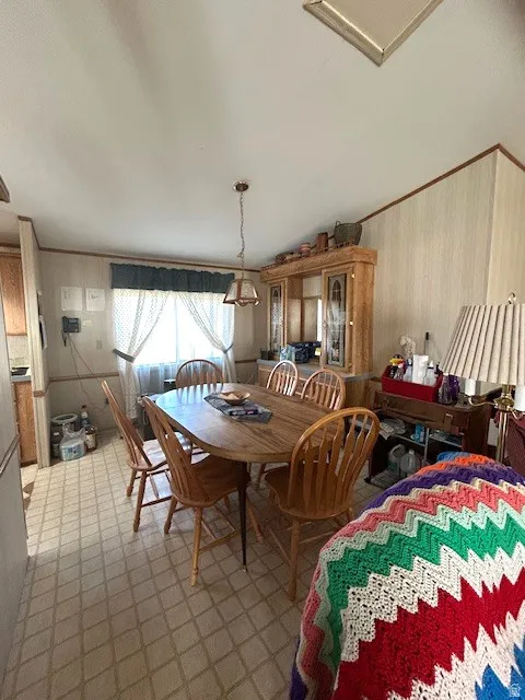 Dining area featuring light flooring and vaulted ceilings