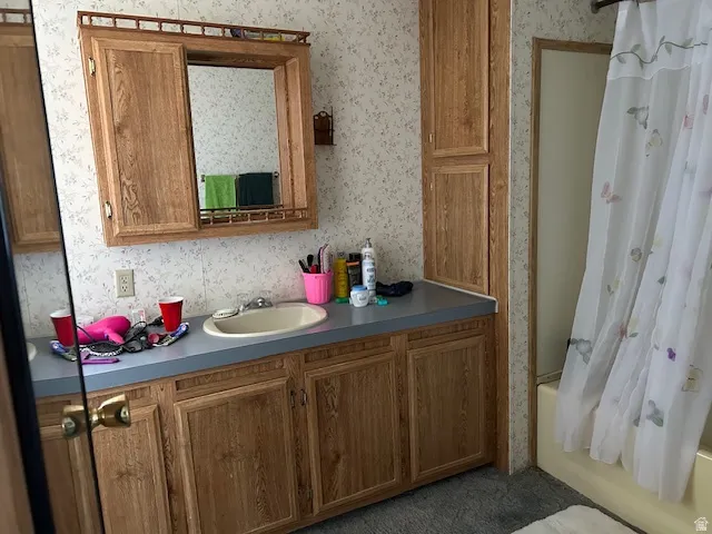 Full bath featuring shower / tub combo, vanity,