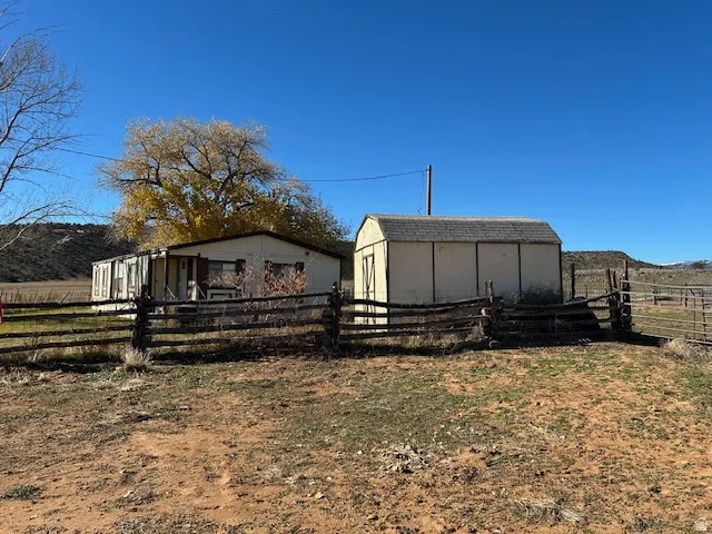 View of side of property with shed