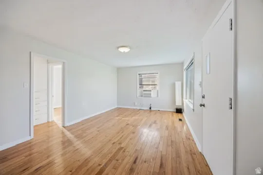 Spare room with light wood finished floors and baseboards