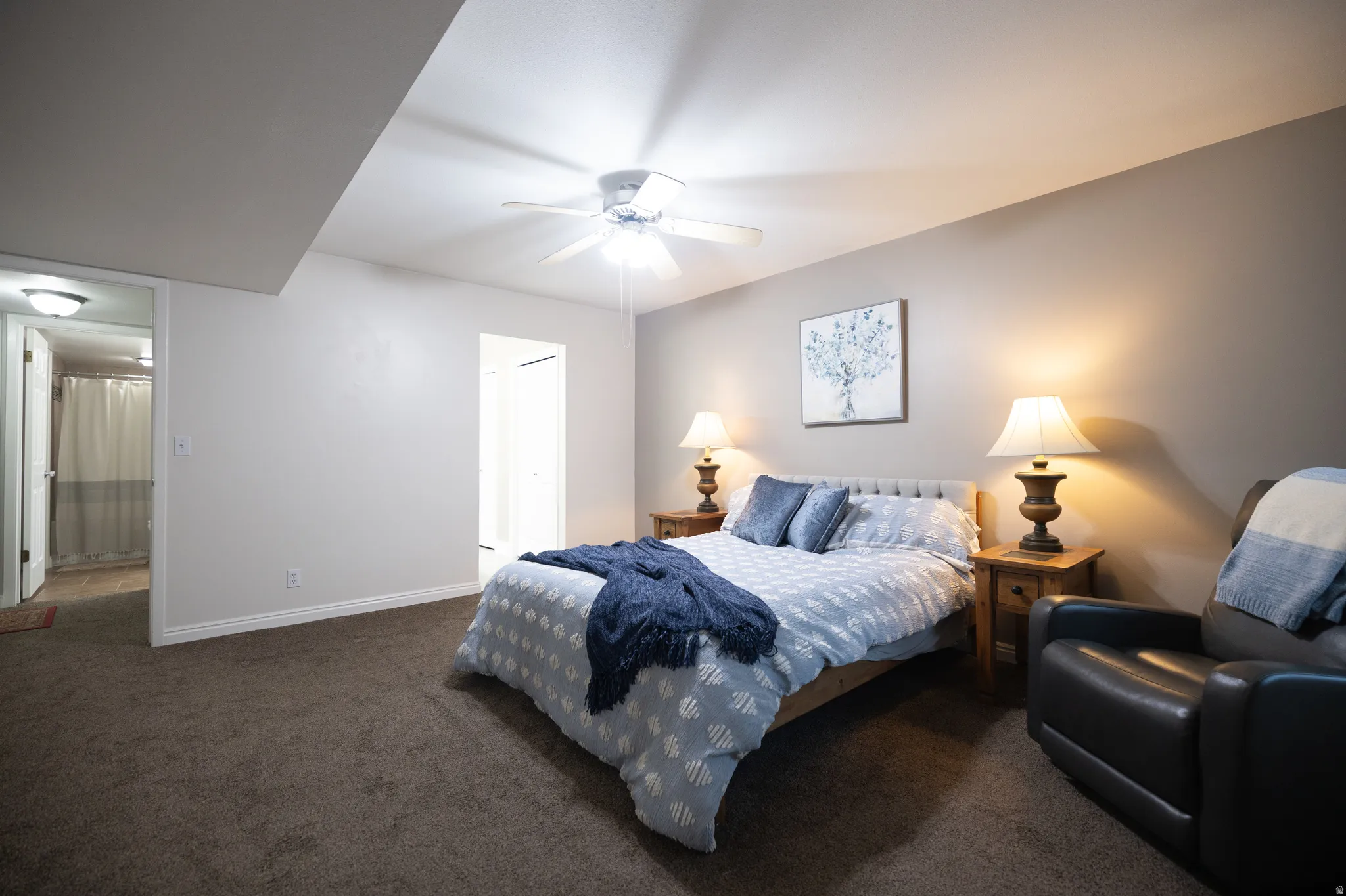 Carpeted bedroom featuring a closet and a ceiling fan