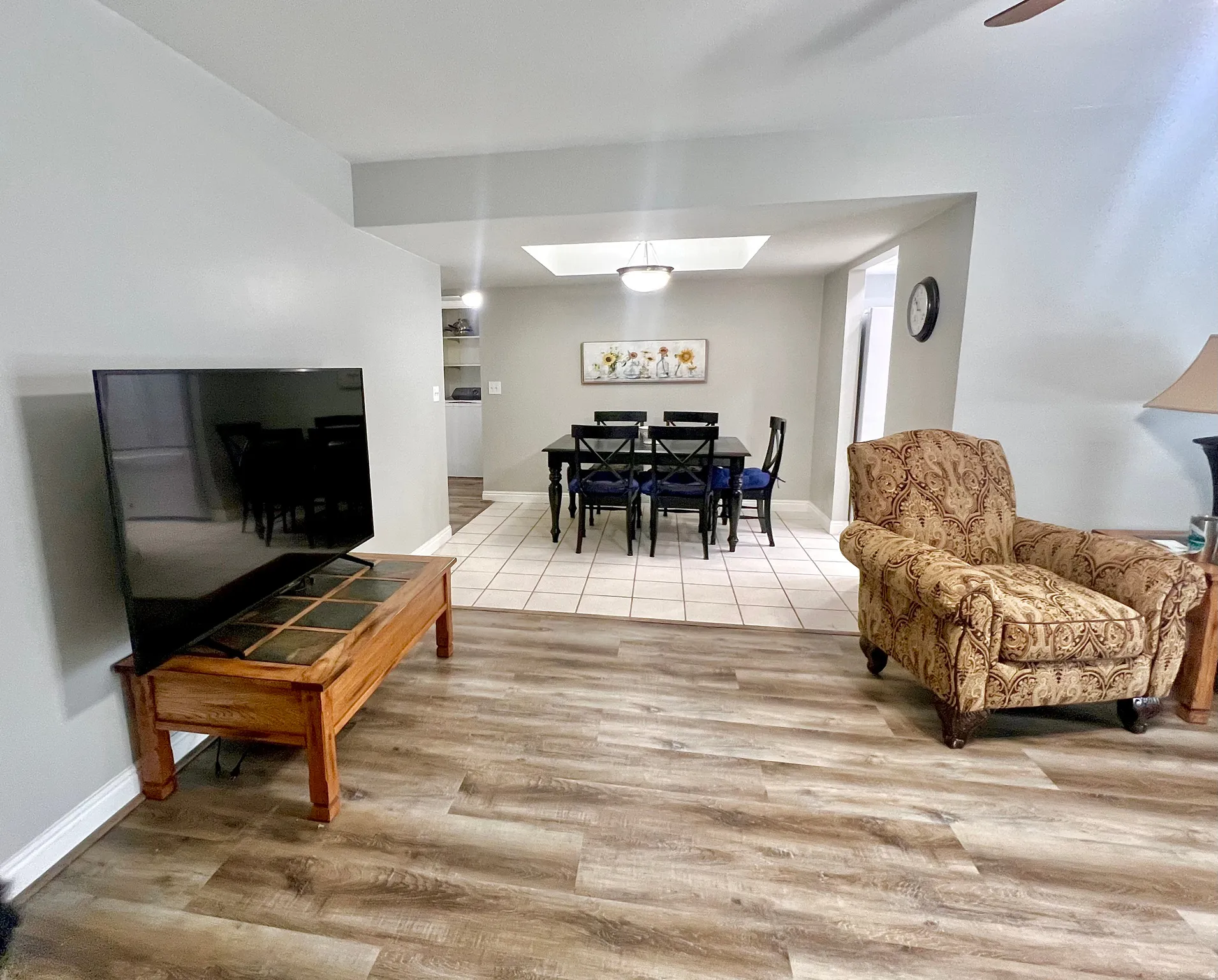 Living area with wood finished floors and a skylight