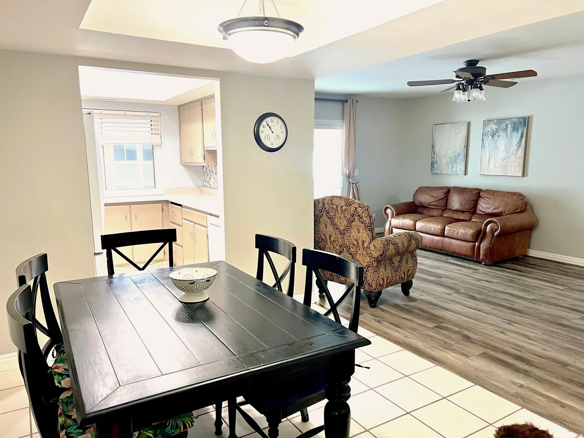 Dining room with light tile patterned floors and ceiling fan