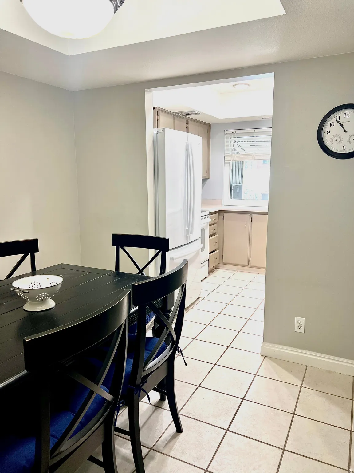 Dining area featuring light tile patterned flooring and baseboards