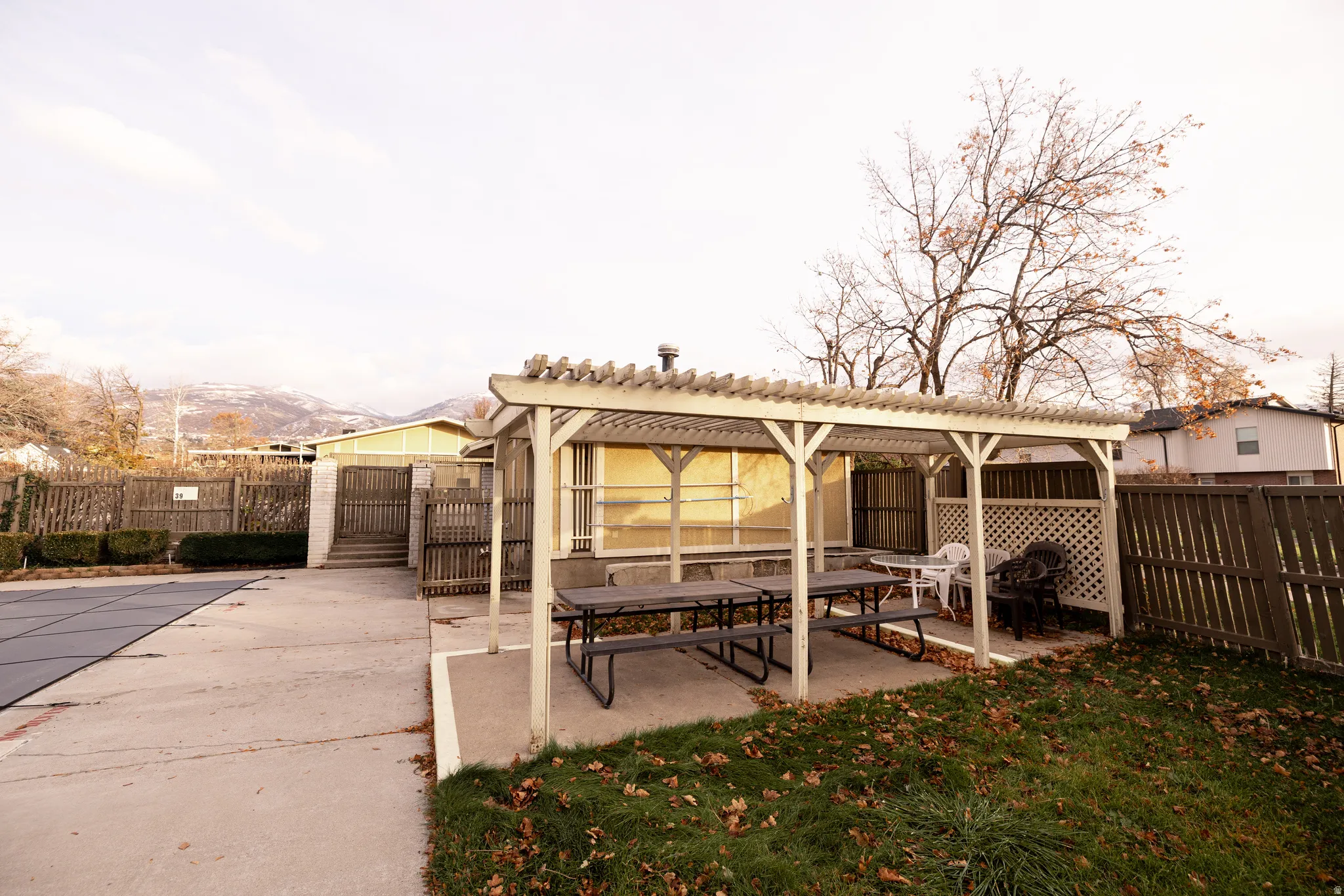 Fenced backyard with a patio and a pergola
