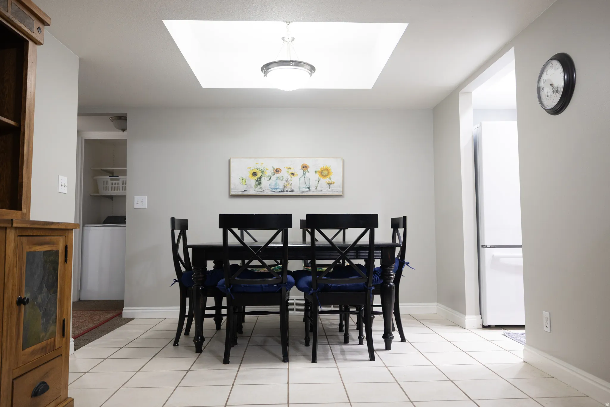 Dining space with washer / clothes dryer and light tile patterned flooring