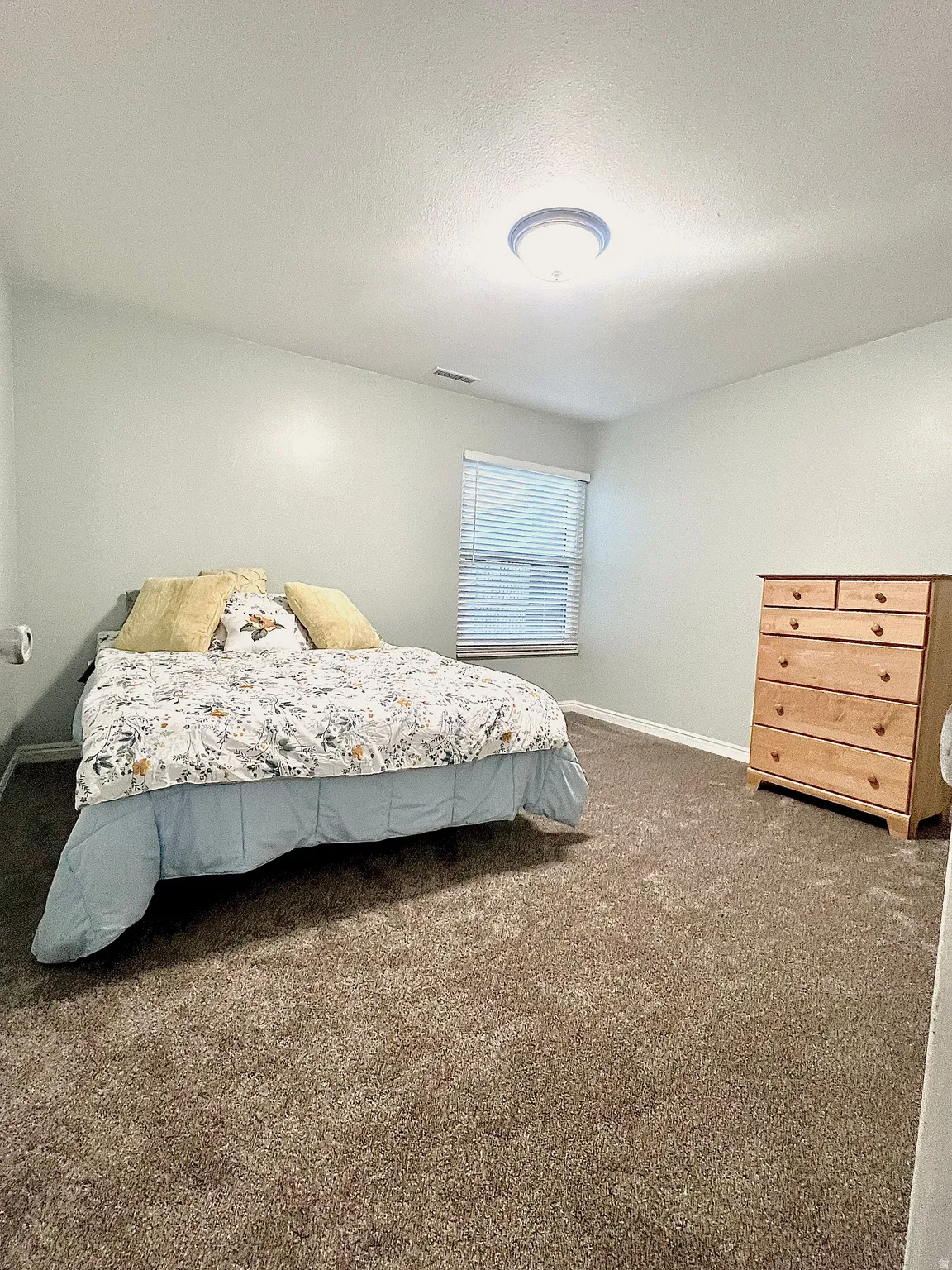 Carpeted bedroom with baseboards