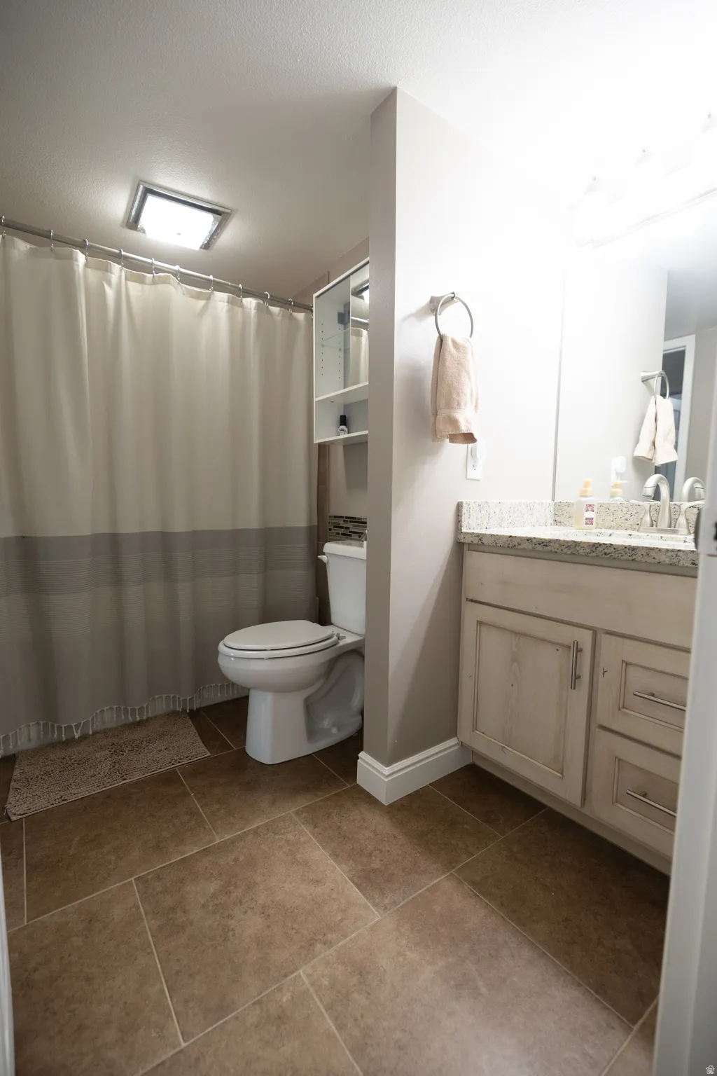 Full bath featuring vanity and a shower with curtain