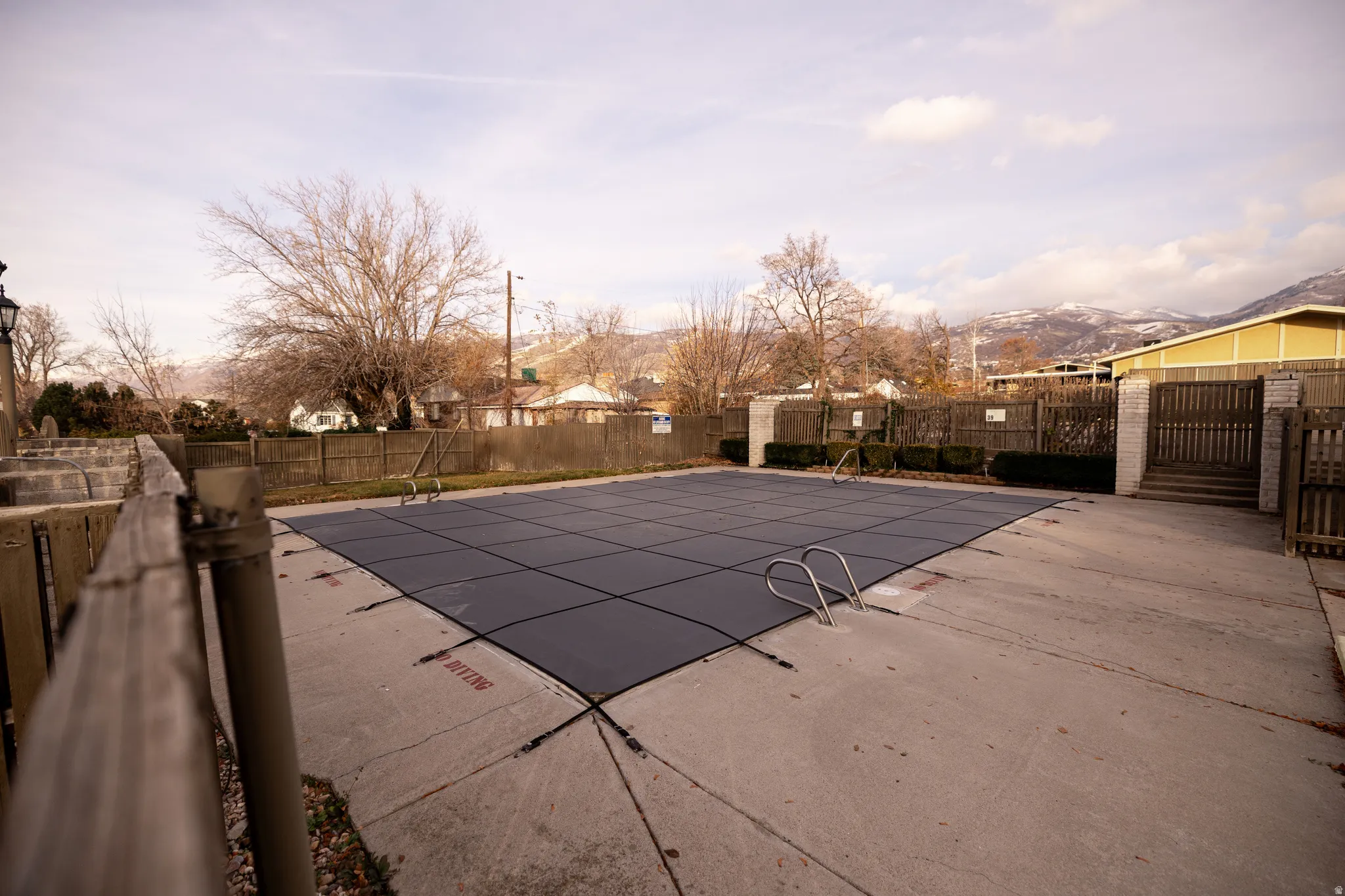 Community pool featuring a fenced backyard and a patio