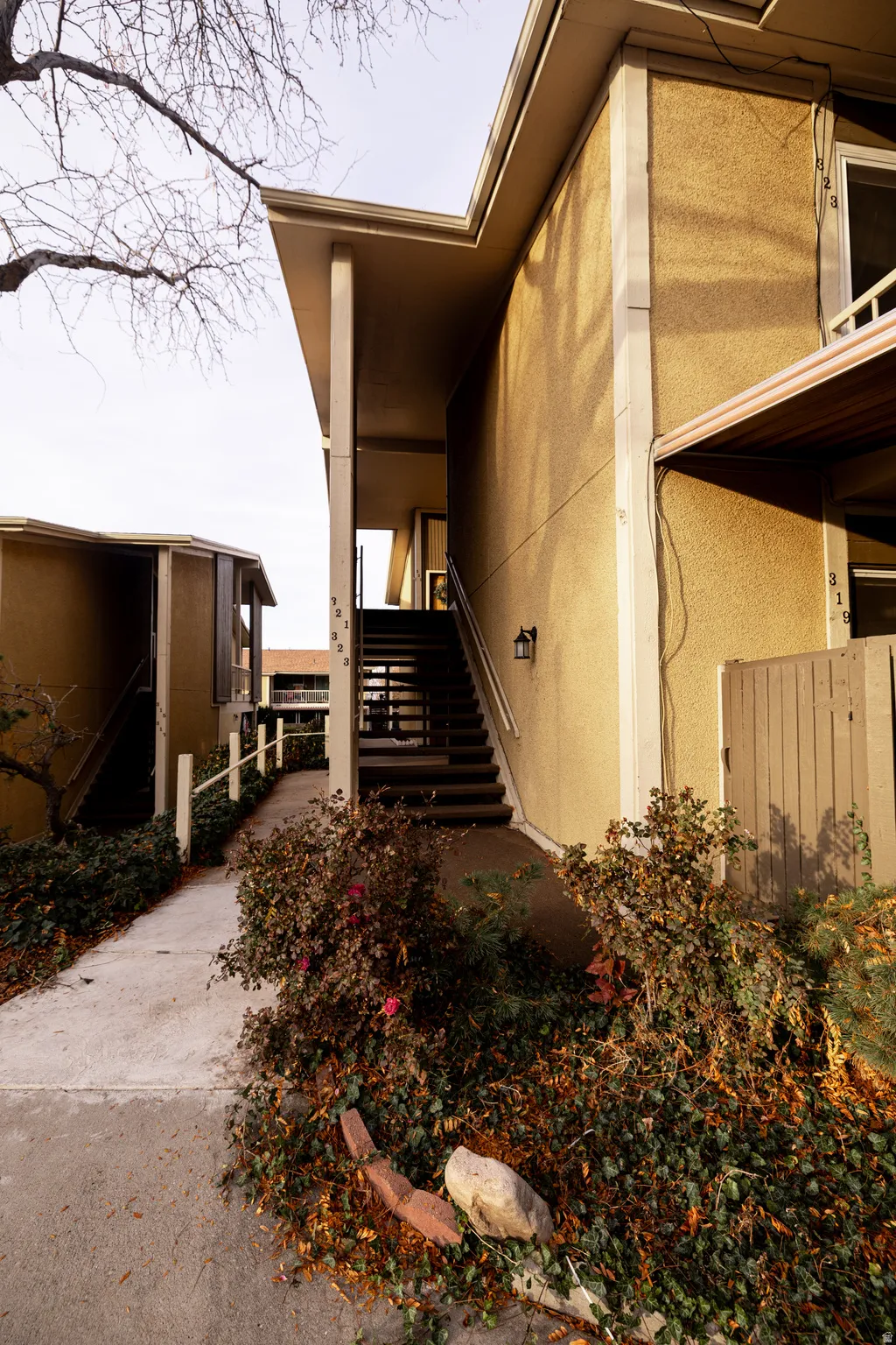 View of home's exterior featuring stairs and stucco siding