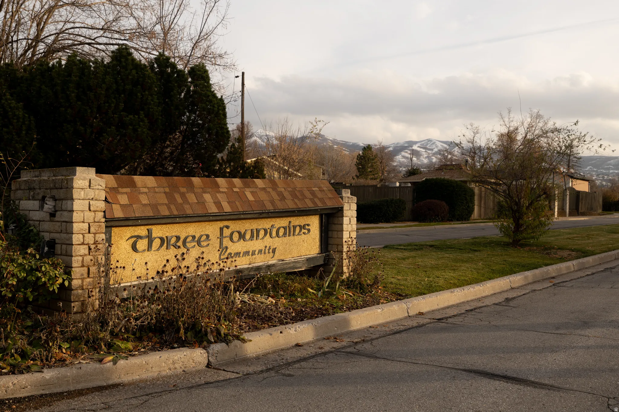 Community sign with a mountain view