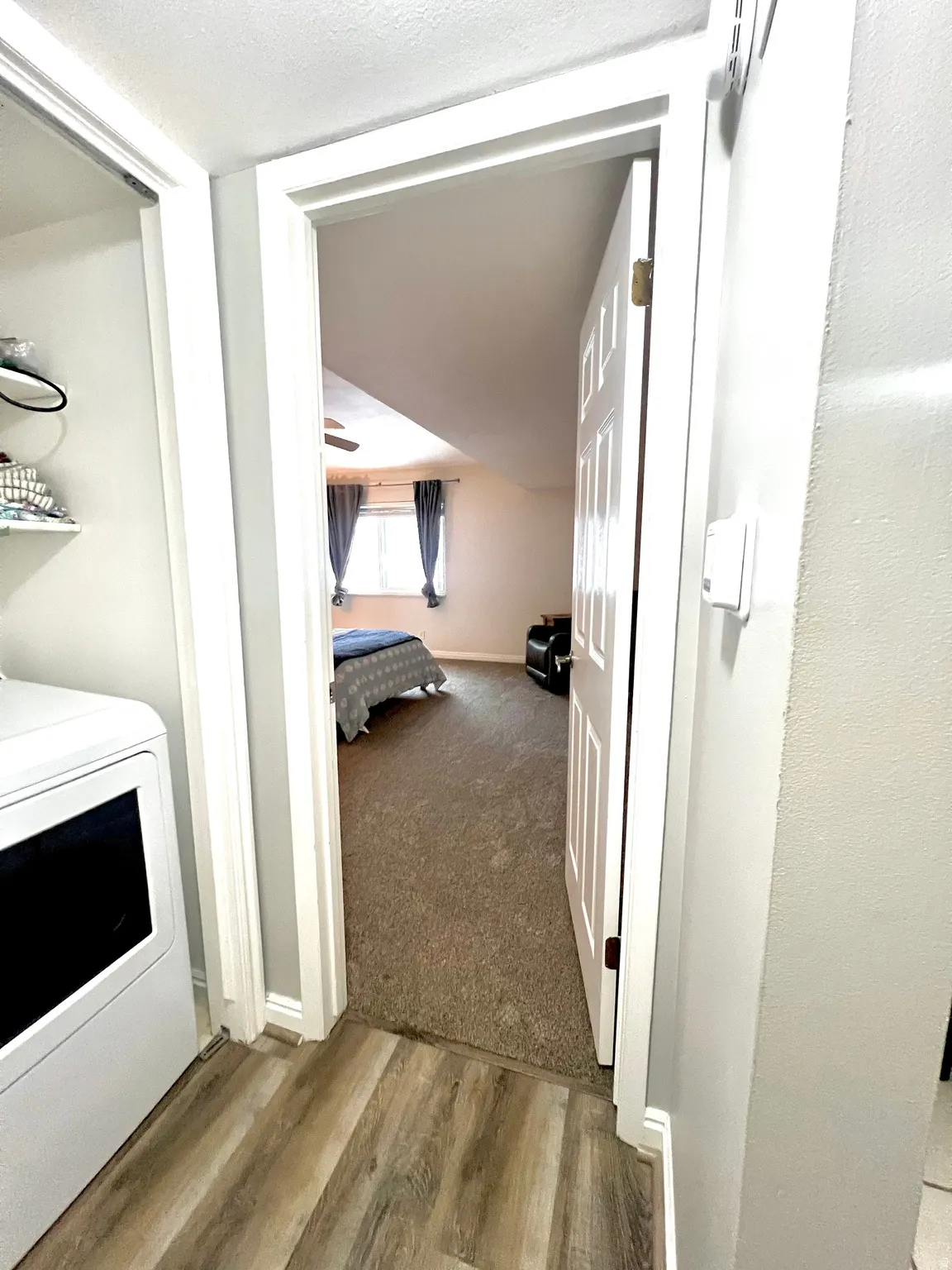 Corridor featuring washer / dryer and wood finished floors