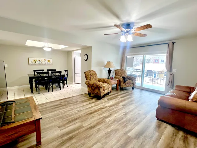 Living area featuring ceiling fan and New wood-style  LPV flooring