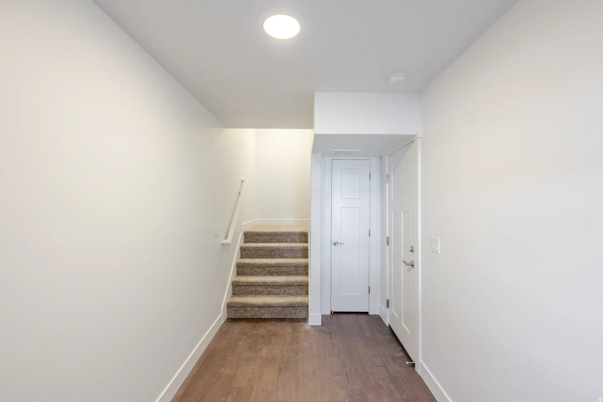 Corridor featuring stairway and dark wood finished floors