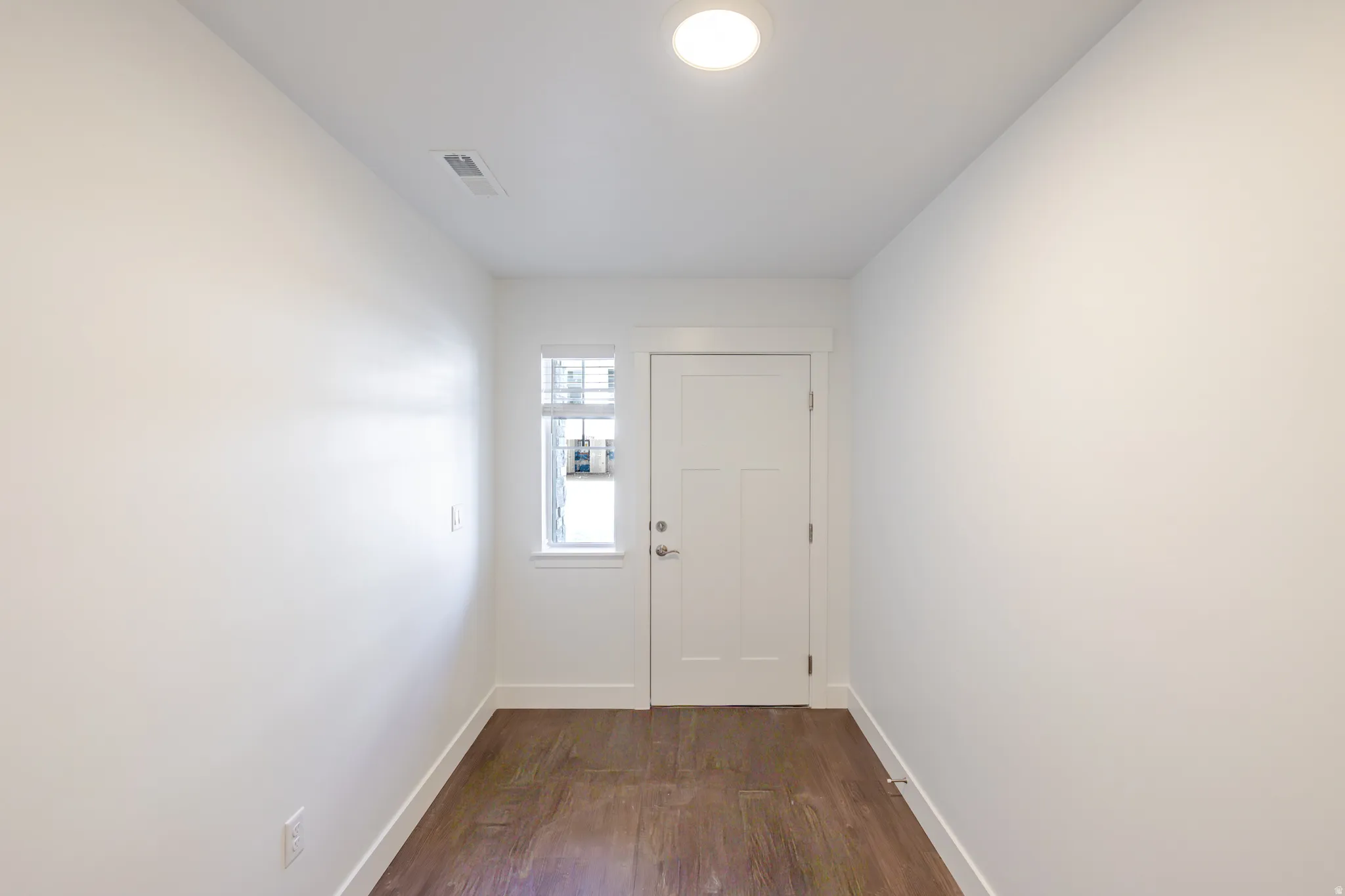 Entryway featuring wood finished floors and baseboards