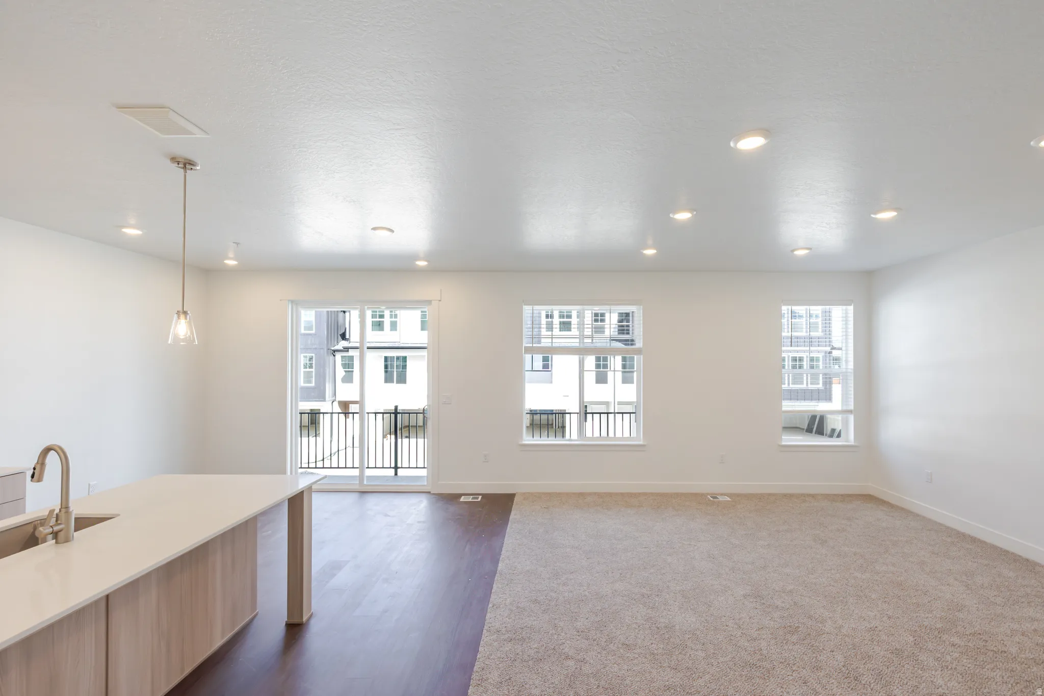 Unfurnished living room featuring dark wood-style floors and recessed lighting