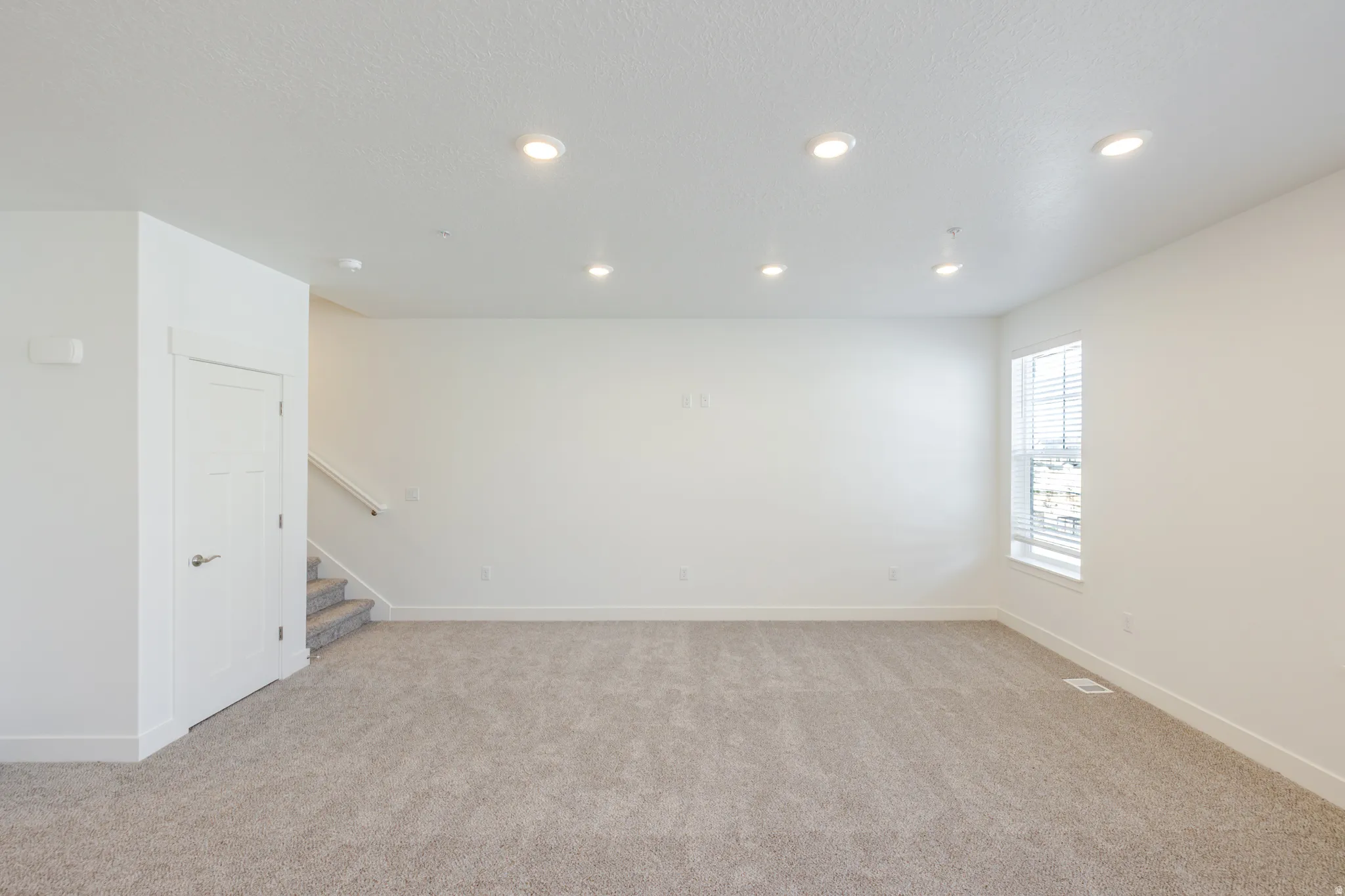 Unfurnished room featuring light carpet and recessed lighting