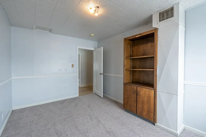 Empty room with light colored carpet