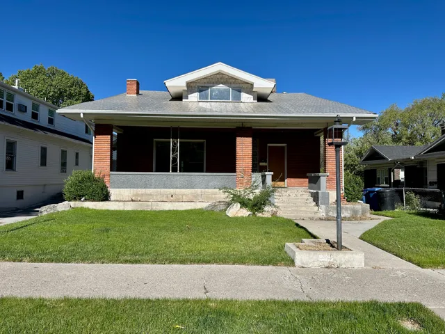 Red brick exterior with a gray-toned roofline, featuring a distinct dormer window