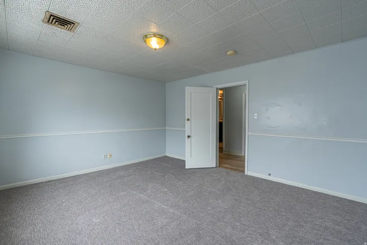 Carpeted spare room with baseboards