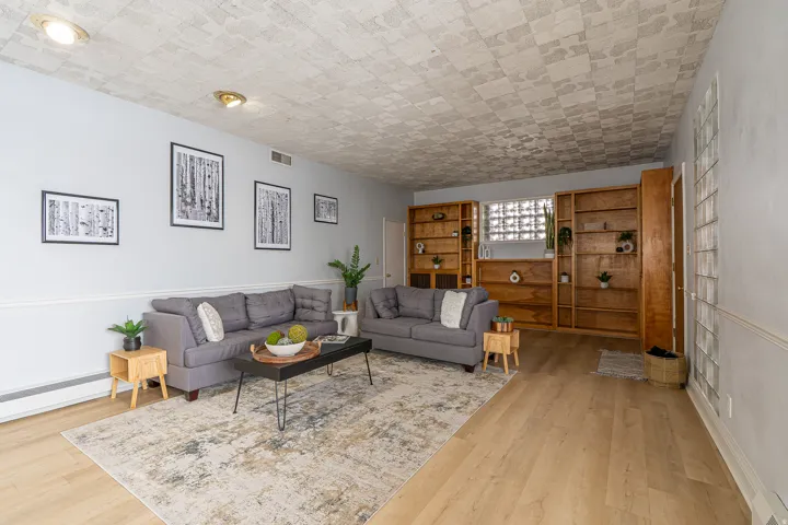 Living area featuring light wood finished floors and baseboard heating