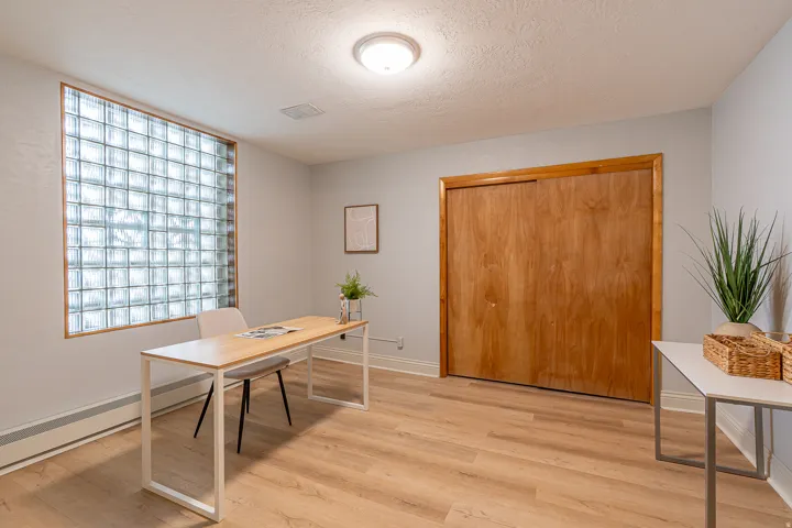 Office space with a textured ceiling, light wood-type flooring, and baseboard heating