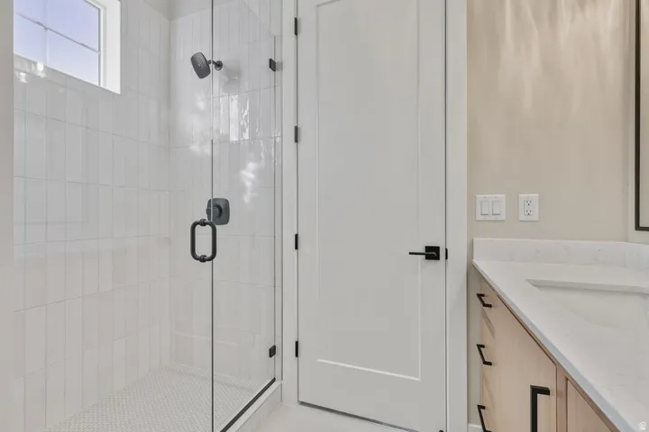 Bathroom featuring vanity and a stall shower