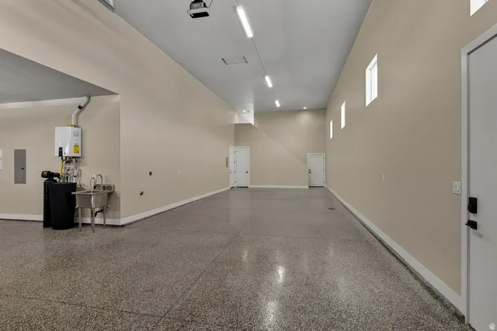 Garage featuring baseboards and electric panel