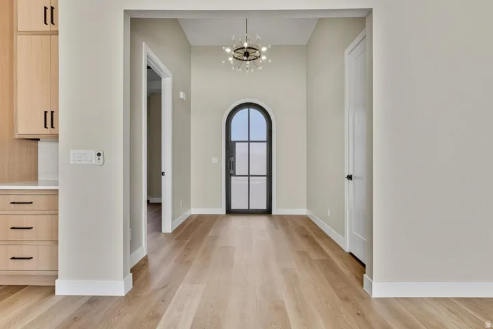 Foyer entrance featuring a chandelier and light wood-style floors