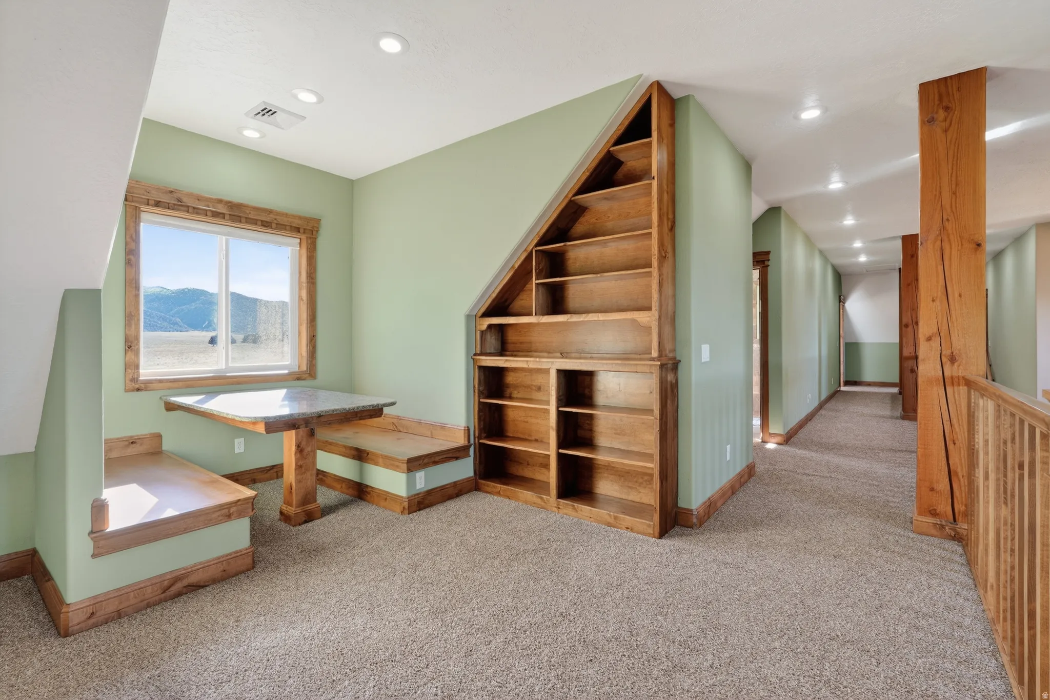 Bonus room with light colored carpet, recessed lighting, and a mountain view